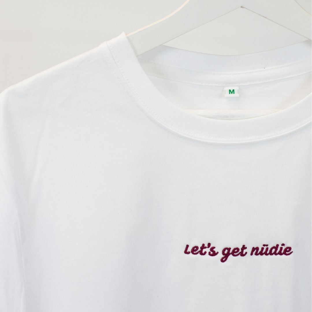 luxury fit organic cotton statement t-shirt- white with embroidered red text along the chest saying "let's get nudie"- £5 per sales goes to supporting ocean plastic pollution solutions
